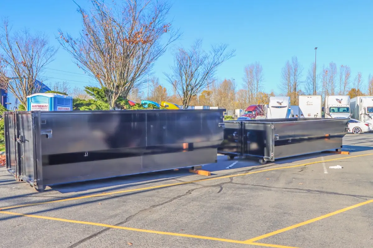 Professional dumpster rental service with roll-off container on residential driveway in Bee Cave